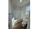 Bathroom featuring a shower-tub combination and window at 90 Pate Landing Dr, Selma, NC 27576