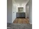 Bathroom view with double vanity, wood look floor, and doorway to walk-in closet at 90 Pate Landing Dr, Selma, NC 27576