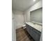 Bathroom featuring wood-look flooring, gray vanity, granite countertop, and a shower-tub combination at 90 Pate Landing Dr, Selma, NC 27576