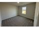 Bedroom with neutral walls, carpet flooring, ample natural light streaming through a large window at 90 Pate Landing Dr, Selma, NC 27576