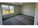 Bedroom with carpet flooring, neutral walls, well-lit by a large window offering views of the surrounding neighborhood at 90 Pate Landing Dr, Selma, NC 27576