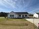 New construction shows charming one-story home with white siding, black shutters, and a well-manicured lawn at 90 Pate Landing Dr, Selma, NC 27576