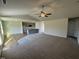 Living room features plush carpets, ceiling fan, neutral walls and an open layout to the kitchen at 90 Pate Landing Dr, Selma, NC 27576