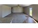 Living room boasts plush carpeting, a ceiling fan, an open layout and seamless transition to the kitchen at 90 Pate Landing Dr, Selma, NC 27576
