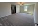 Large carpeted bedroom featuring a ceiling fan, window, and ensuite bathroom at 90 Pate Landing Dr, Selma, NC 27576