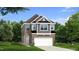 Charming two-story home featuring a brick and siding facade, a two-car garage, and a well-manicured lawn at 206 Faith Ave, Sanford, NC 27330