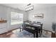 Bright dining area featuring a modern chandelier, large windows, and seating for six at 1005 Cookwood Ct, Raleigh, NC 27610