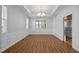 Spacious dining room with elegant wainscoting, hardwood floors, and stylish chandelier, perfect for gatherings at 105 Harkness Cir, Durham, NC 27705