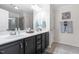 Bathroom boasts double vanity, framed mirror, and a mix of neutral and modern decor at 107 Vickery Hill Ct, Durham, NC 27703