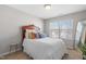 Bright bedroom with queen bed, wood headboard, patterned pillows, and a sun-drenched window at 107 Vickery Hill Ct, Durham, NC 27703