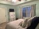 Well-lit bedroom featuring a large window, closet, and white dresser at 107 Vickery Hill Ct, Durham, NC 27703