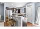 The spacious kitchen has stainless steel appliances, granite countertops and dark wood cabinets at 107 Vickery Hill Ct, Durham, NC 27703