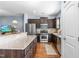 Modern kitchen featuring stainless steel appliances, granite countertops, and dark wood cabinetry at 107 Vickery Hill Ct, Durham, NC 27703