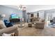 Open-concept living room with a ceiling fan, modern furnishings, and seamless transition to kitchen area at 107 Vickery Hill Ct, Durham, NC 27703