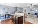 Open-concept living space with hardwood floors, granite kitchen island and a casual dining area at 107 Vickery Hill Ct, Durham, NC 27703