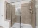 New shower features decorative tile with a built-in seat and glass doors at 107 Vickery Hill Ct, Durham, NC 27703