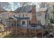 Rear exterior view of a two-story home with a brick chimney and a screened porch at 108 N Fern Abbey Ln, Cary, NC 27518