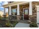 Inviting front porch with stone columns and charming front door at 110 Lodgepole Ln, Burlington, NC 27215