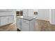 Kitchen island features white cabinets, granite countertops and stainless steel hardware at 110 Lodgepole Ln, Burlington, NC 27215