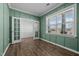 Bright office with French doors, wainscoting and wood-look floors at 110 Lodgepole Ln, Burlington, NC 27215