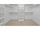 Spacious walk-in closet with built-in shelves and wooden rods for optimal organization at 110 Lodgepole Ln, Burlington, NC 27215