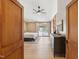 Main bedroom with wood door frame, dresser, neutral walls, slider to exterior, and ceiling fan at 11408 Hickory Grove Church Rd, Raleigh, NC 27613