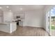 Dining area featuring wood-look flooring, neutral paint, and sliding glass doors leading to the backyard at 129 Paper Birch Way, Fuquay Varina, NC 27526