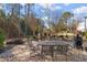 Backyard with a stone patio, a stone fireplace, and outdoor furniture for relaxing or entertaining at 1301 Mackinaw Dr, Wake Forest, NC 27587