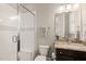 Well-lit bathroom features a tiled shower, toilet, and vanity with granite countertop at 1301 Mackinaw Dr, Wake Forest, NC 27587