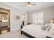 Sunlit bedroom features a ceiling fan, two windows with blinds, and doorways leading to other rooms at 1301 Mackinaw Dr, Wake Forest, NC 27587