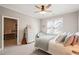 Well-lit bedroom with a ceiling fan, window, cozy chair, dresser, and doorway to another room at 1301 Mackinaw Dr, Wake Forest, NC 27587