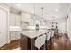 Bright kitchen with white cabinetry, granite countertops, large island, and pendant lighting at 1301 Mackinaw Dr, Wake Forest, NC 27587