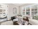 Bright sitting area with a comfortable chair, tufted ottoman, and large windows offering lots of natural light at 1301 Mackinaw Dr, Wake Forest, NC 27587