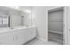 Bathroom featuring a double sink vanity, large mirror, neutral walls and wood flooring at 138 Clear Water Rd, Louisburg, NC 27549