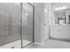 Bathroom featuring a glass shower, and a double sink vanity with neutral walls and wood flooring at 138 Clear Water Rd, Louisburg, NC 27549
