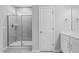 Bathroom featuring a glass shower, white vanity and neutral walls and wood flooring at 138 Clear Water Rd, Louisburg, NC 27549
