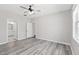 Bright bedroom with an ensuite bathroom featuring wood flooring and neutral walls at 138 Clear Water Rd, Louisburg, NC 27549