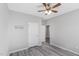 This bedroom features a ceiling fan, gray walls, and wood-look flooring at 138 Clear Water Rd, Louisburg, NC 27549