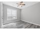 Cozy bedroom featuring a ceiling fan, a large window and wood flooring at 138 Clear Water Rd, Louisburg, NC 27549