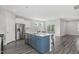 Open-concept kitchen featuring an island with bar seating, stainless steel appliances, and modern finishes at 138 Clear Water Rd, Louisburg, NC 27549