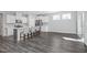 Open living room featuring kitchen with island seating, modern flooring, and natural light at 138 Clear Water Rd, Louisburg, NC 27549