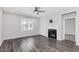 Inviting living room with a fireplace, ceiling fan, built-in shelving and sleek wood flooring at 138 Clear Water Rd, Louisburg, NC 27549