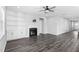 Comfortable living room featuring a fireplace, ceiling fan, built-in shelving, and wood flooring at 138 Clear Water Rd, Louisburg, NC 27549