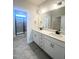 Modern bathroom features a double vanity, white cabinets and drawers, and a glass-enclosed shower at 138 Oban Dr, Homesite 134, Sanford, NC 27330