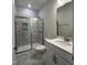 Bathroom featuring a glass shower door, marble tile, and a modern vanity at 138 Oban Dr, Homesite 134, Sanford, NC 27330