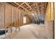 Unfinished attic showing wood beams and a window providing natural light at 140 Southern Acres Dr, Fuquay Varina, NC 27526