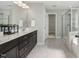 Bathroom featuring a double sink vanity with dark wood cabinets, glass shower, and tile floors at 140 Southern Acres Dr, Fuquay Varina, NC 27526