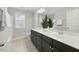 Modern bathroom featuring a double sink vanity with dark wood cabinets and bright marble countertops at 140 Southern Acres Dr, Fuquay Varina, NC 27526