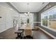 Dining area featuring a long table, bench seating, and large windows with natural light at 140 Southern Acres Dr, Fuquay Varina, NC 27526