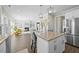 Open kitchen and living area featuring a large island with seating and modern appliances at 140 Southern Acres Dr, Fuquay Varina, NC 27526